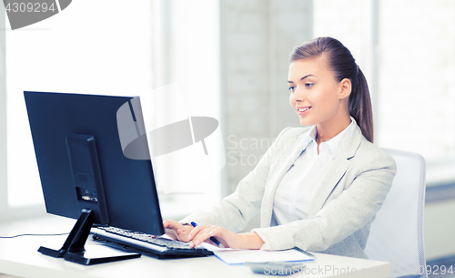 Image of businesswoman with computer in office