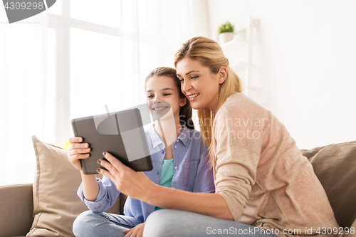 Image of happy family with tablet pc at home
