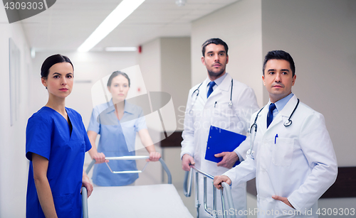 Image of group of doctors with gurney at hospital