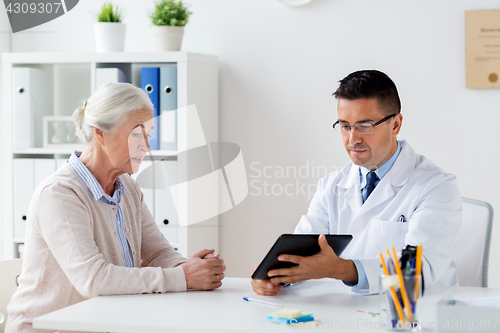 Image of senior woman and doctor with tablet pc at hospital