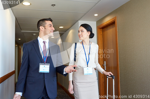 Image of business team with travel bags at hotel corridor