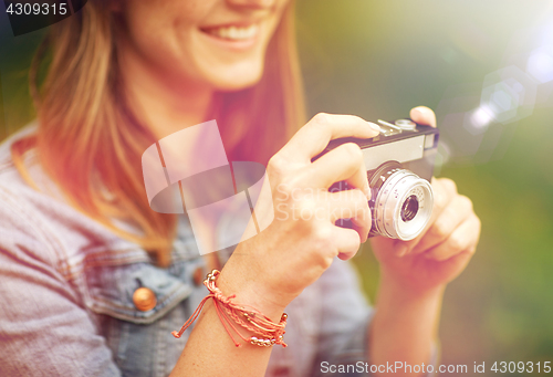 Image of close up of woman with camera shooting outdoors