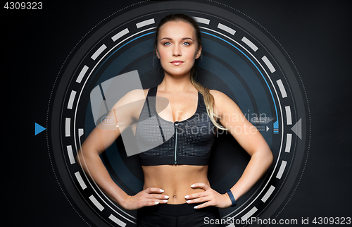 Image of young woman in black sportswear posing