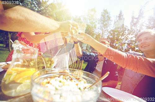 Image of happy friends with drinks at summer garden party