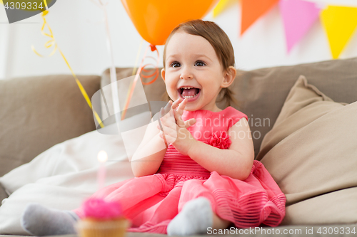 Image of happy baby girl on birthday party at home