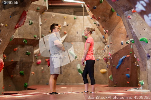 Image of man and woman talking at indoor climbing gym