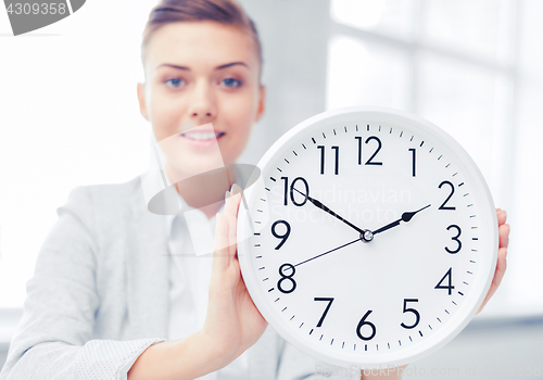 Image of attractive businesswoman with white clock