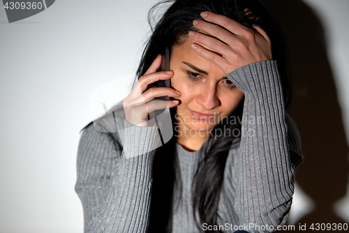 Image of close up of crying woman calling on smartphone
