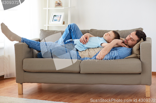Image of happy father and son sleeping on sofa at home