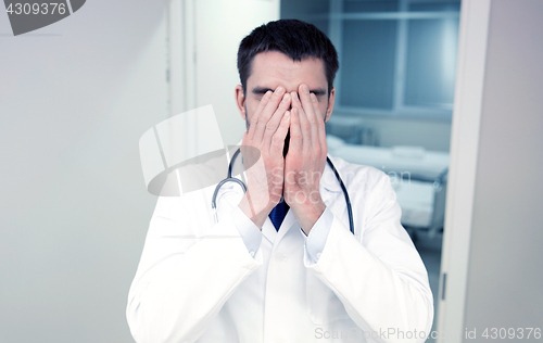 Image of sad or crying male doctor at hospital ward