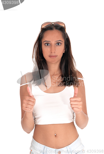 Image of Young woman standing with thumbs up