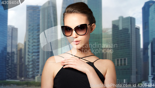 Image of beautiful young woman in elegant black sunglasses