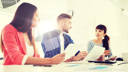 Image of happy creative team or students working at office