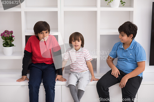 Image of young boys posing on a shelf