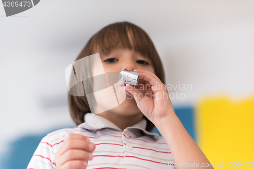 Image of kid blowing a noisemaker