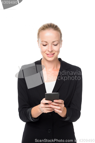 Image of Beautiful young caucasian businesswoman using mobile phone.