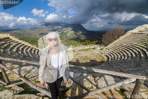 Image of Tourist taking photo in front of greek theater of Segesta, Sicily, Italy