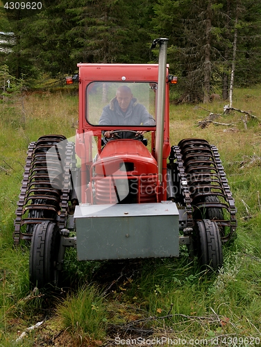 Image of Man in old abandoned tractor