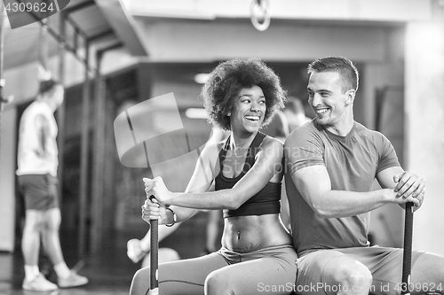 Image of multiethnic couple after workout with hammer