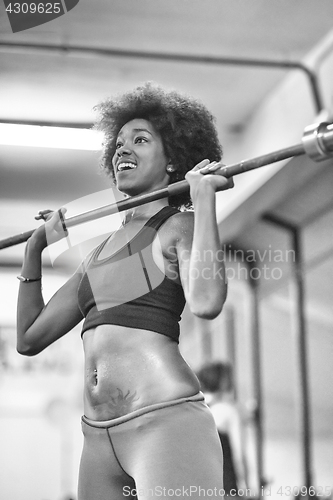 Image of black woman lifting empty bar