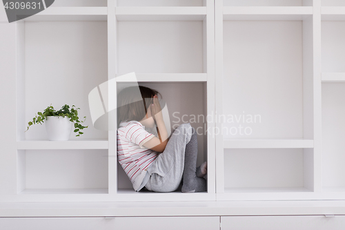 Image of young boy posing on a shelf