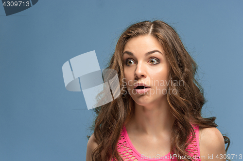 Image of Portrait of young woman with shocked facial expression