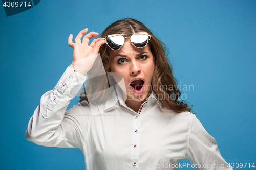 Image of Portrait of young woman with shocked facial expression