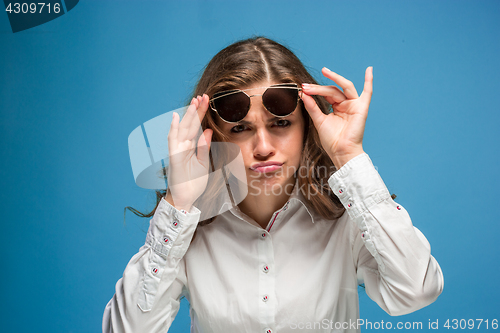 Image of Portrait of young woman with shocked facial expression