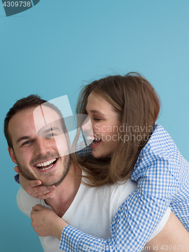 Image of young man piggybacking his girlfriend
