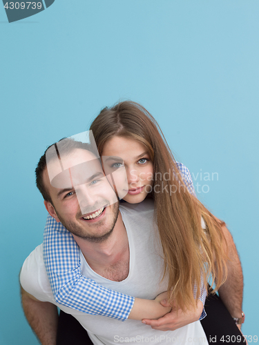 Image of young man piggybacking his girlfriend