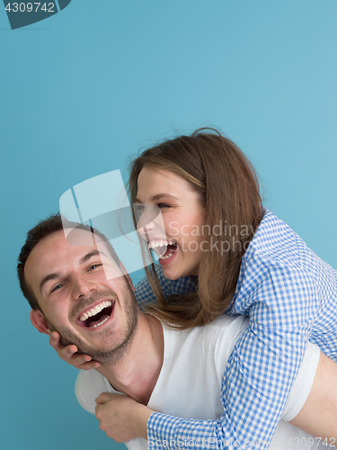 Image of young man piggybacking his girlfriend