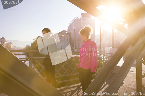 Image of healthy young couple jogging in the city