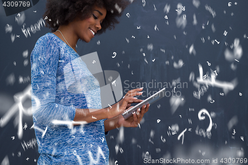 Image of Happy African American Woman Using Digital Tablet