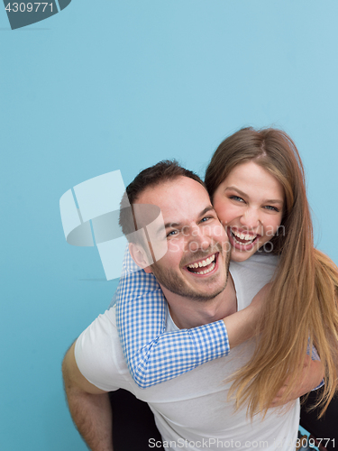 Image of young man piggybacking his girlfriend
