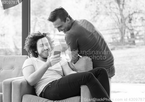 Image of Two friends watching video