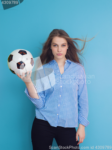 Image of young woman playing with a soccer ball