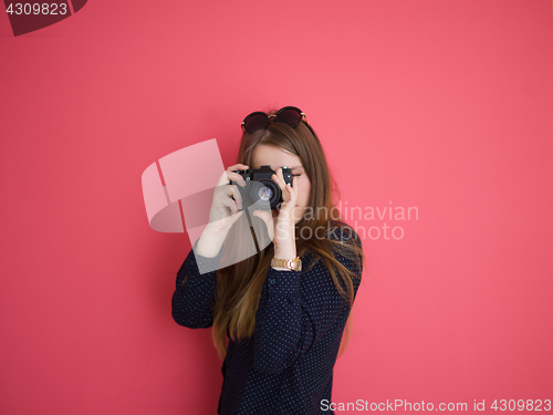 Image of girl taking photo on a retro camera