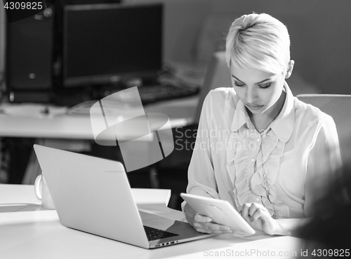 Image of Businesswoman using tablet at work