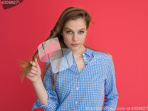 Image of woman playing with her long silky hair