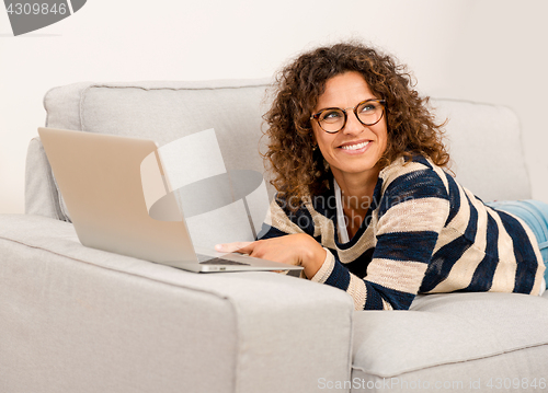 Image of Beautiful woman working at home