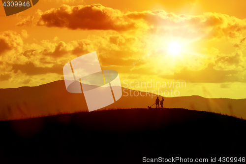 Image of a couple and the dog out for a walk