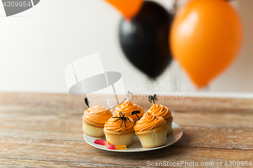 Image of halloween party decorated cupcakes on plate