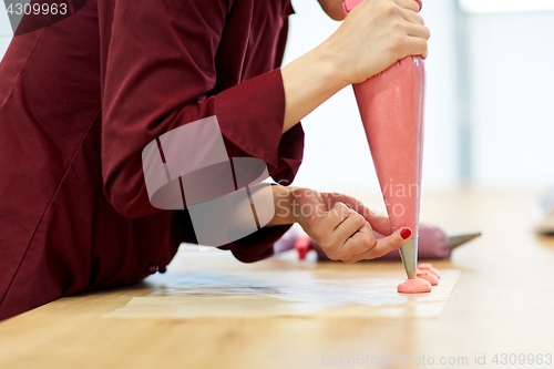 Image of chef with injector squeezing macaron batter