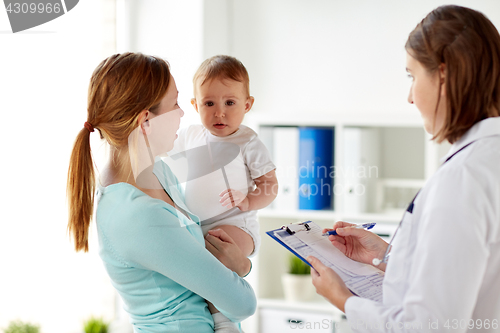 Image of happy woman with baby and doctor at clinic