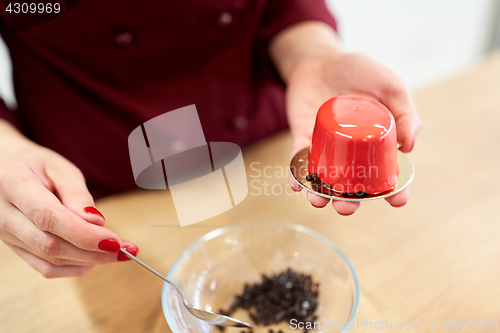 Image of chef decorating mirror glaze cakes at pastry shop