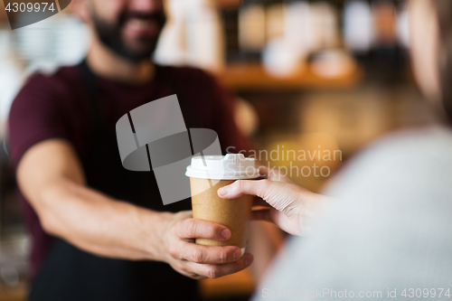 Image of man or bartender serving customer at coffee shop