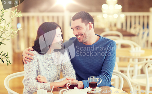 Image of happy couple drinking tea at restaurant