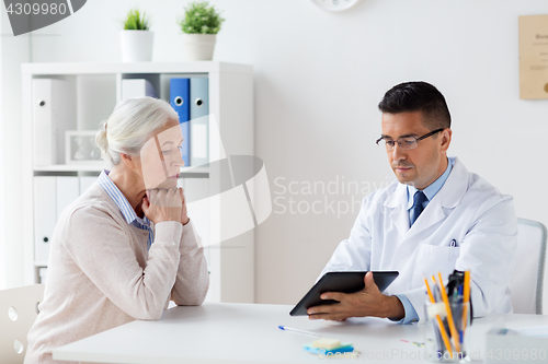 Image of senior woman and doctor with tablet pc at hospital