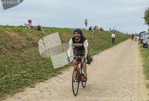 Image of Amateur Cyclist Riding on a Cobblestone Road - Tour de France 20