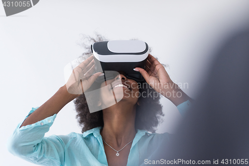 Image of black girl using VR headset glasses of virtual reality